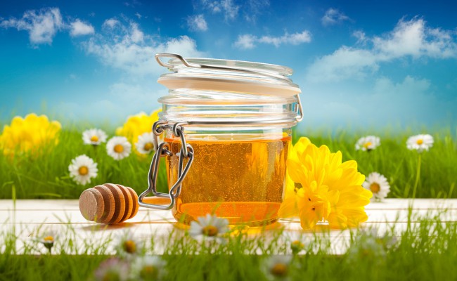 Jar of honey and spring flowers